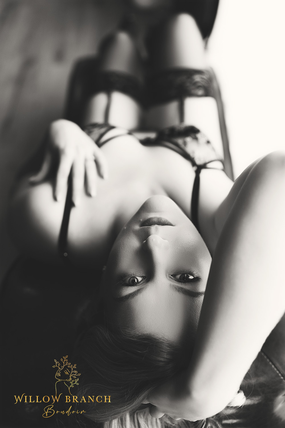 Upper Coomera boudoir glamour session with elegant posing and styling, black and white photo of woman posing on lounge.