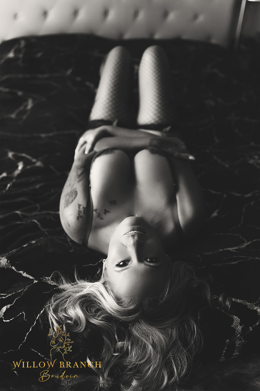 Client doing a Boudoir session After coming out of a Toxic Relationship, posing on bed, black and white photo